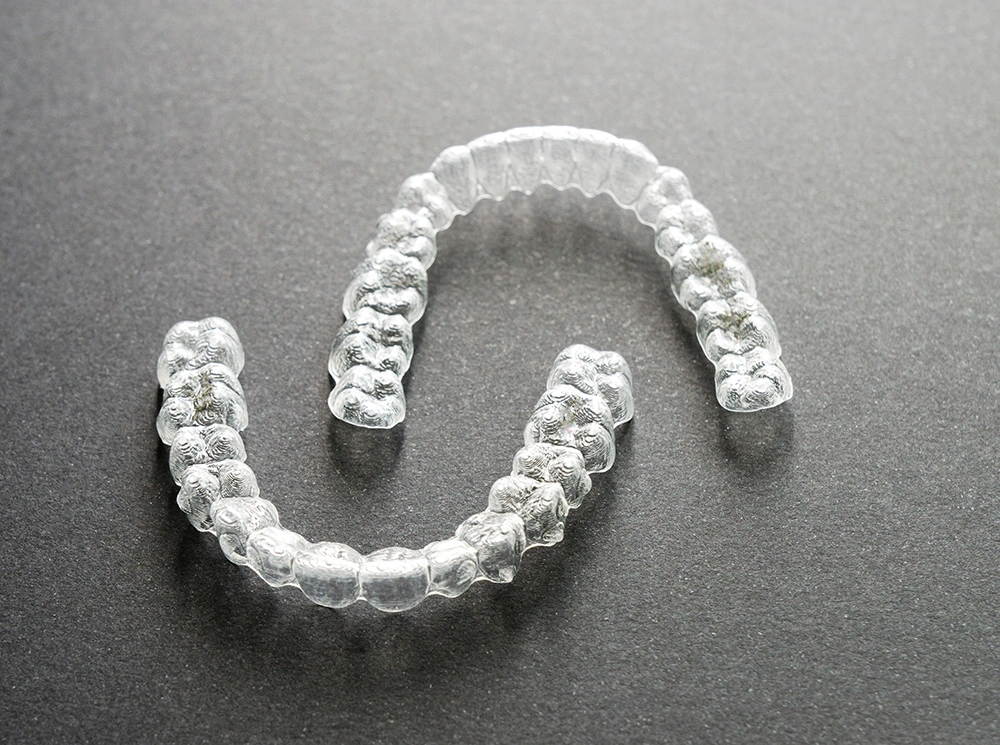 close-up-of-clear-orthodontic-aligners-splints-on